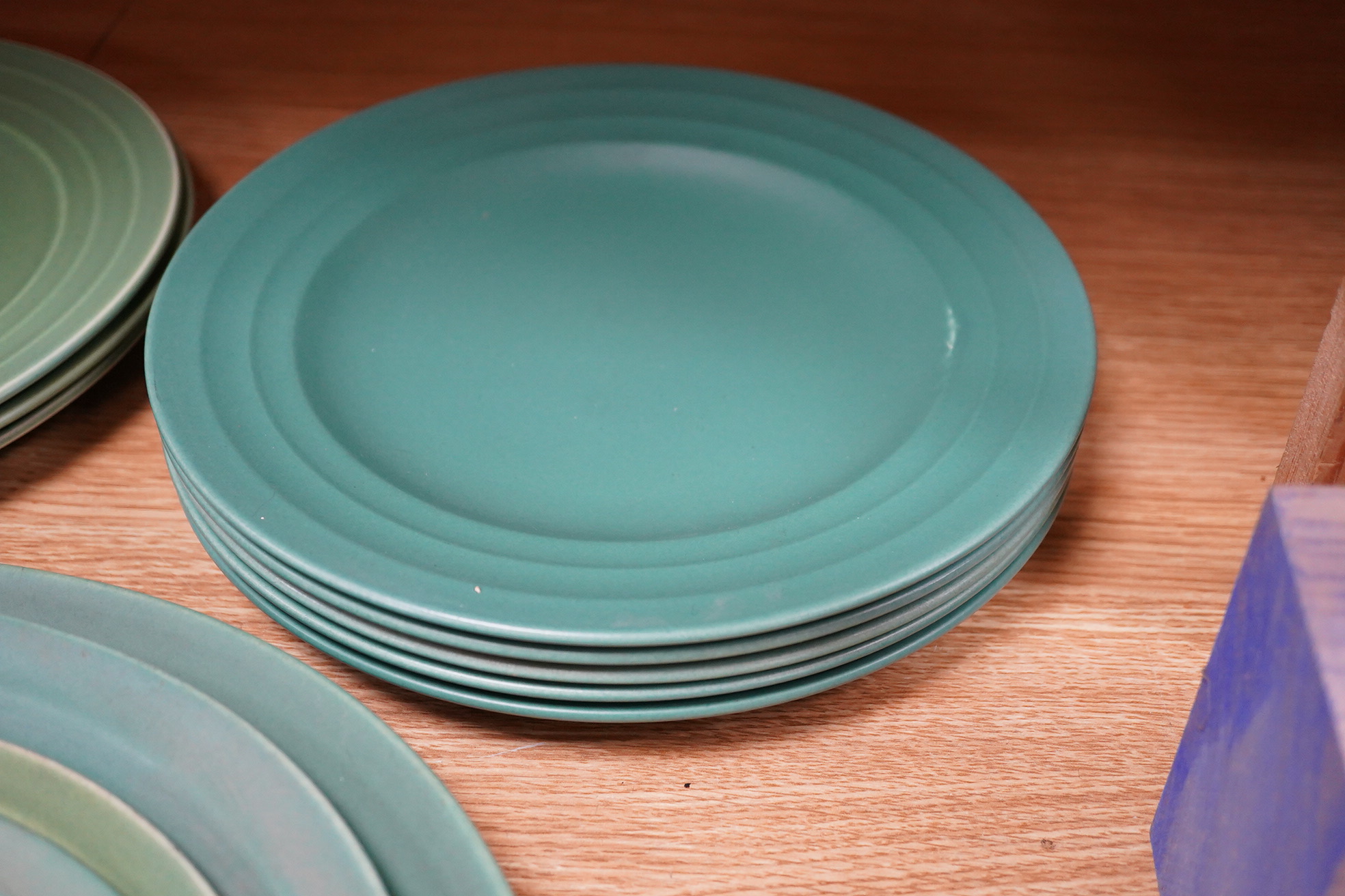 Keith Murray for Wedgwood, Annular part service comprising plates and two oval serving dishes, largest 38cm wide